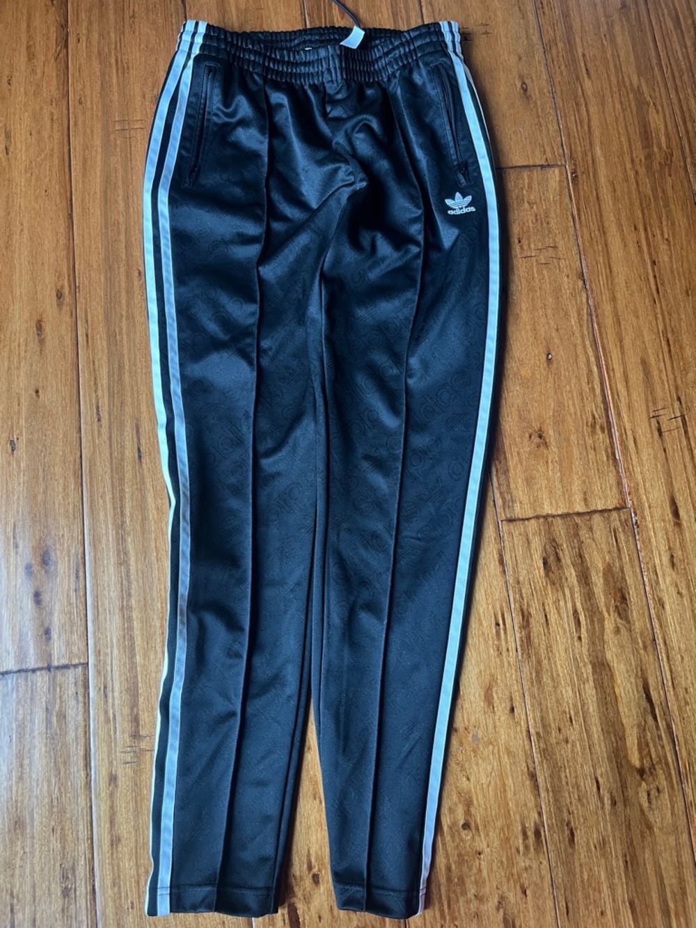 Unisex Adidas Black Joggers with White  Strip- faint Adidas pattern throughout.
